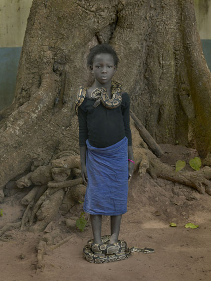 Nahaume Ouielle, 8 ans, with Daba Dre Snakes, Temple Des Pythons, Ouidah, Benin, 2011 &copy; Albert Watson