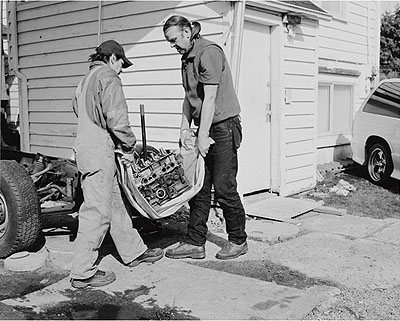 Jeff WallMen move an engine block, 2008Silver gelatin print134.6 x 170 cm53 x 67 inchesEdition of 3 + 1 APCourtesy Marian Goodman Gallery, New York, Paris