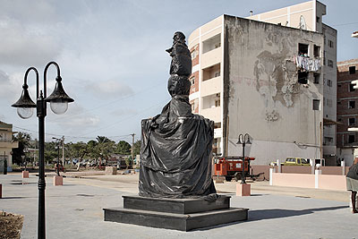 Guy TillimNew town square with wrapped statue of Agostinho Neto, Sumba, Angola, 20082008Archival pigment ink on cotton rag paper91.5 x 131.5 cmCourtesy Kuckei + Kuckei