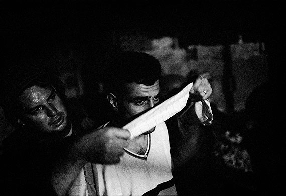 Blindfolded suspects are lined up before being taken to the soldiers base near a Jewish settlement, Palestine, 2002 © Paolo Pellegrin/Magnum Photos/Contrasto