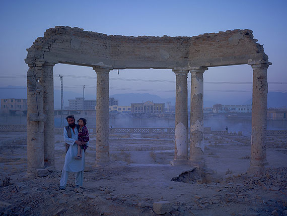 Jaw Aka Faizal Nahman and his daughter Nono from Bamiyan province, now
living in an improvised plastic shelter in the ruined gardens of Darulaman Palace. Built in the 1920s to house an Afghan parliament, 'Darul Aman' translates as 'abode of peace'. Kabul, 201040x53