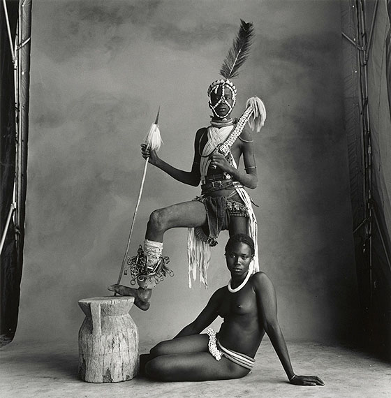 IRVING PENNStanding Warrior, Sitting Girl, Cameroon, 1969Gelatin silver print toned in selenium mounted to boardc. 45 x 43 cm Edition of 5© The Irving Penn Foundation
