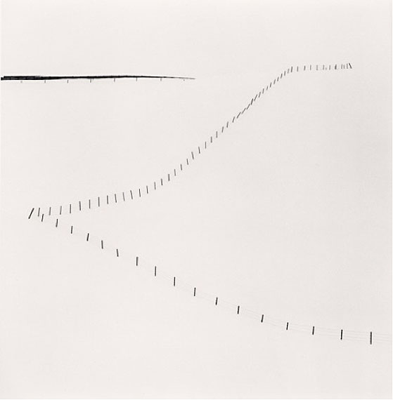 “Hillside FenceSilver gelatin print. 20cm x 20cm - Edition of 45. , Study 6, Teshikaga, Hokkaido, Japan” (2007)© Michael Kenna. Courtesy of m97 Gallery.