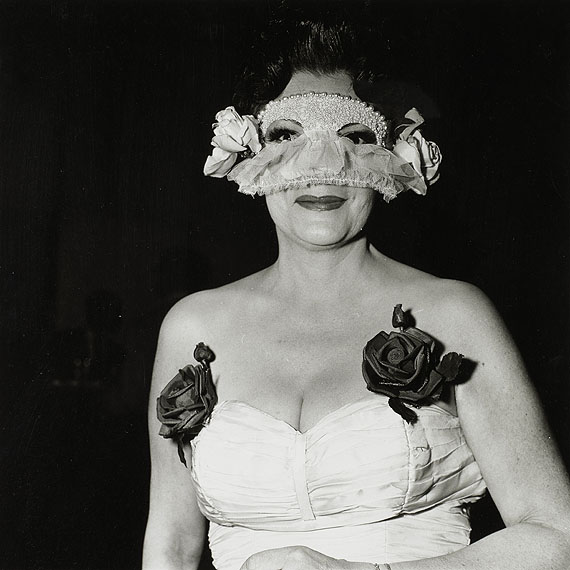 LOT 36Diane ArbusLady at a masked ball with two roses on her dress, N.Y.C., 1967
