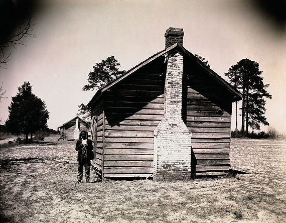 Walker Evans: Man Posing for Picture in Front of Wooden House, 1936 © Walker Evans Archive, The Metropolitan Museum of Art