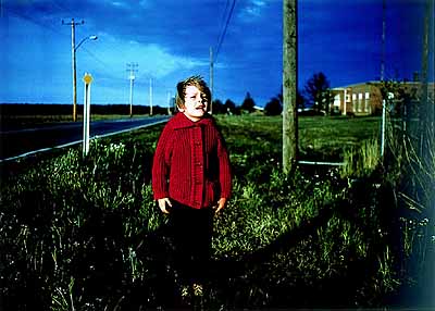 William Eggleston, Untitled (Boy in Red Cardigan) 1971, Dye-transfer print, 323 x 450 mm, credit: Pinakothek der Moderne, Munich, Siemens artsprogram, Dauerleihgabe der Siemens Aktiengesellschaft © 2003 The Eggleston Artistic Trust
