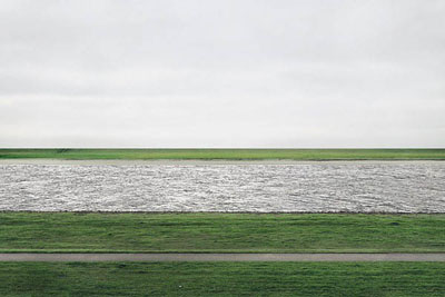 ANDREAS GURSKY (B. 1955) Rhein II signed 'Andreas Gursky' (on a paper label affixed to the backing board) chromogenic color print face-mounted to Plexiglas image: 73 x 143 in. (185.4 x 363.5 cm.)overall: 81 x 151a x 2 in. (207 x 385.5 x 6.2 cm.)Executed in 1999. This work is number one from an edition of six.© ANDREAS GURSKY, COURTESY OF CHRISTIE'S